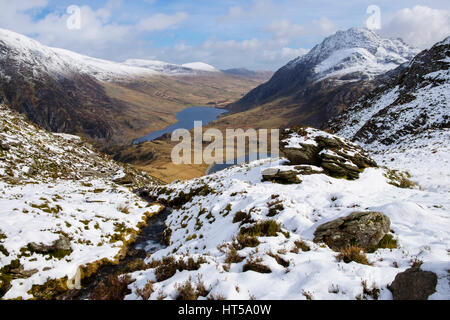 High view to Ogwen Valley and Mount Tryfan from Cwm Clyd on Y Garn with snow in Snowdonia National Park mountains. Ogwen, Gwynedd, North Wales, UK Stock Photo