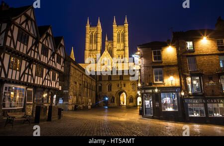 A dusk-time view of Lincoln Cathedral viewed from Castle Hill.  The view takes in the sights of Exchequer Gate, the Magna Carta public house and the T Stock Photo