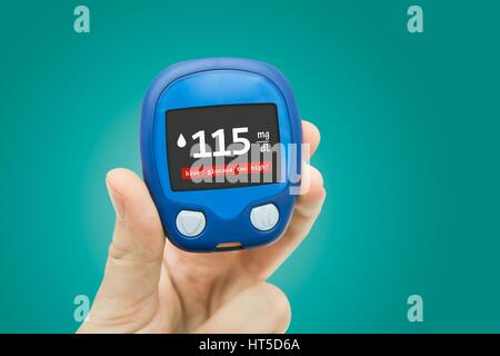 Hand holding meter. Diabetes doing glucose level test. Medical background concept Stock Photo