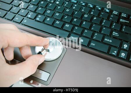 Diagnosis and repair of computers. Stethoscope on laptop Stock Photo