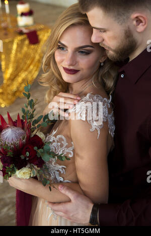 Bride and groom pose at wedding ceremony Stock Photo