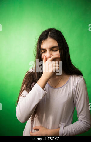 girl in her nightie wants to sleep and yawns on a green background isolated chroma key Stock Photo