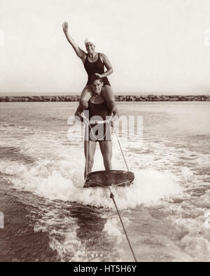 Olympic champions Johnny Weissmuller (Tarzan) and Helen Meany aquaplaning behind a motorboat in Long Island Sound near Rye Beach in New York in 1929. Stock Photo