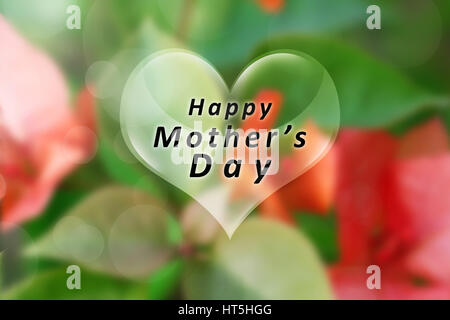 Happy Mothers Day message written on heart shape over blurred background Stock Photo