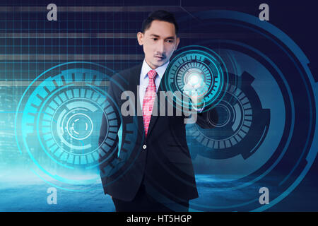 Young asian businessman touching digital screen with finger on digital background Stock Photo