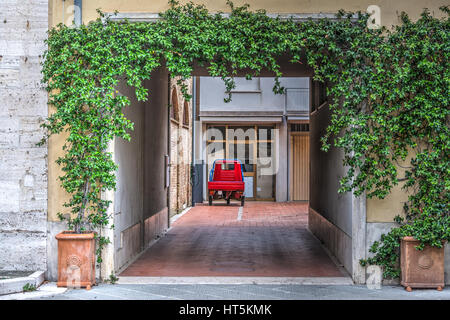 Three-wheeler car in a courtyard in Tuscany, Italy Stock Photo