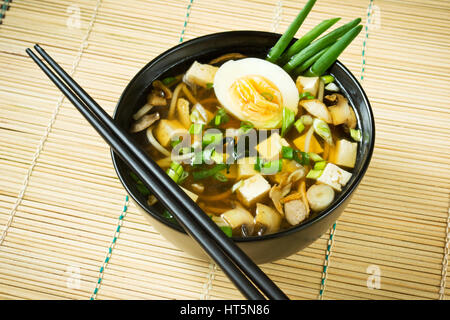 Miso soup in black bowl Stock Photo