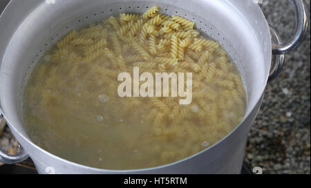 pasta called FUSILLI in Italy cooked in the very hot water in large pot of restaurant in Rome Italy Stock Photo