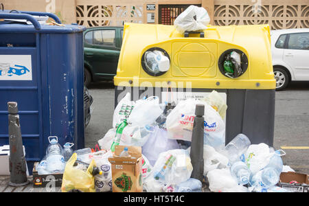 Plastic bottles and bags piled up against recycling container on Gran Canaria in the Canary Islands, Spain. Stock Photo