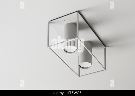 Trendy light lamp on the light ceiling. Closeup. Horizontal. Stock Photo