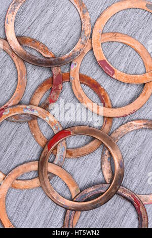 Old Copper Washers on Metal Background, Top View Stock Photo