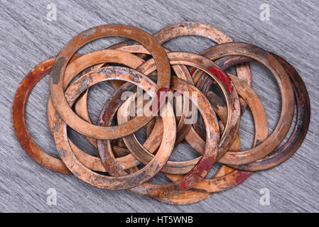 Old Copper Washers on Metal Background, Top View Stock Photo