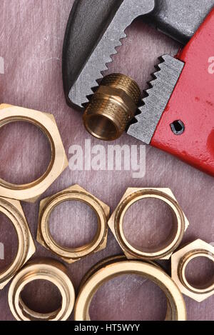 Wrench and brass fittings closeup Stock Photo