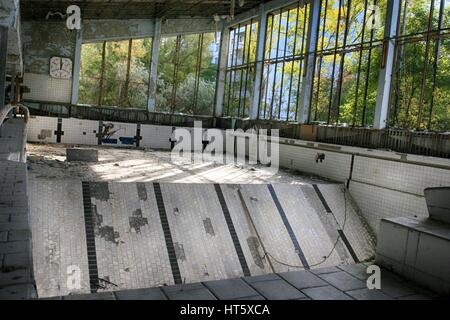 Abandoned swimming pool in Pripyat, the ghost town in the Chernobyl Exclusion Zone Stock Photo