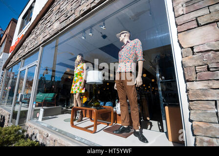 Two mannequins dressed in vintage clothing pose in a shop window in the tourist and shopping district of Kensington Market, Toronto Ontario Canada Stock Photo