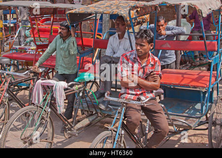 Owners of cycle rickshaws awaiting customers in the Chandni Chowk area of old Delhi, India Stock Photo