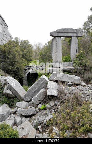 Door-ruins of the gymnasium built in grey stone ashlars in the baths area next to the top gate of the city in the current Gulluk Dagi-Termessos Milli  Stock Photo