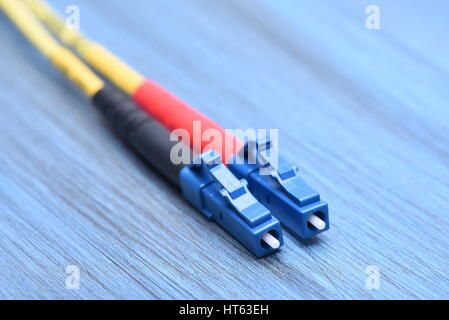Close up of fiber optical cables single mode with  LC type plug on blue background Stock Photo