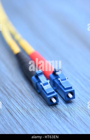 Close up of fiber optical cables single mode with  LC type plug on blue background Stock Photo