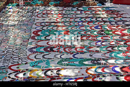 Handcrafted necklaces and other accessories displayed at the Wednesday flea market in Anjuna beach in Goa, India Stock Photo