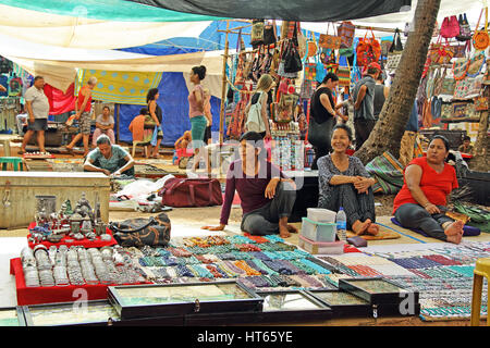 Shops, vendors and customers at the Wednesday flea market selling varieties of merchandise at Anjuna beach in Goa, India. Stock Photo