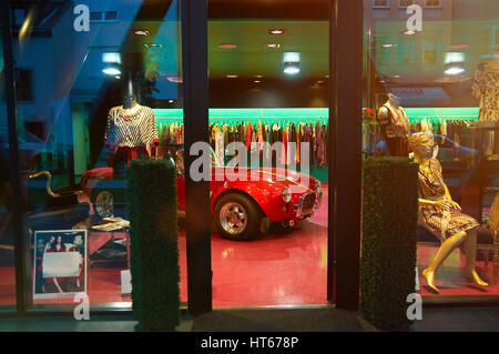 Minsk, Belarus - May 21, 2011: Luxury dress shop entrance with retro red car style inside Stock Photo