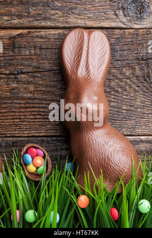 Delicious chocolate Easter bunny and eggs on wooden background Stock Photo