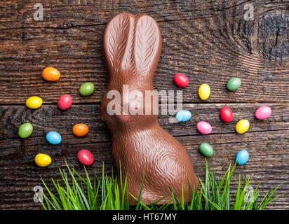 Delicious chocolate Easter bunny and eggs on wooden background Stock Photo