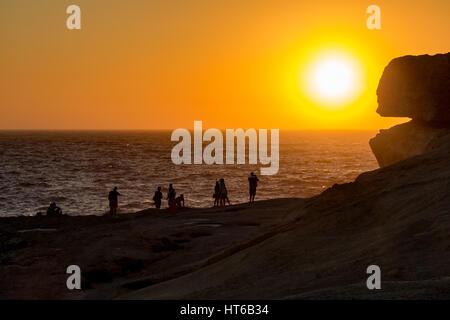Silhouettes of people by the Azure Window, Malta Stock Photo