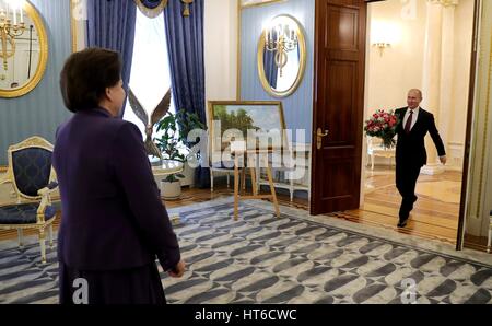 Russian President Vladimir Putin enters carrying flowers to congratulate cosmonaut Valentina Tereshkova, on her 80th birthday at the Kremlin March 6, 2017 in Moscow, Russia. Tereshkova was the first woman in space aboard the Vostok 6 on June 16, 1963. Stock Photo