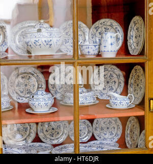 Display case of bone china tableware. Stock Photo