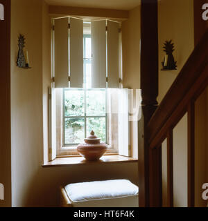 Vase on windowsill with stool. Stock Photo