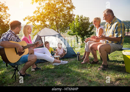 Happy family camping in the park Stock Photo