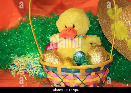 An image showing the concept of Easter with a basket full of colorful eggs Stock Photo