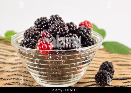 juicy blackberries and raspberries in a glass bowl Stock Photo