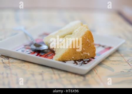 Slice of white cake on a colorful square plate Stock Photo