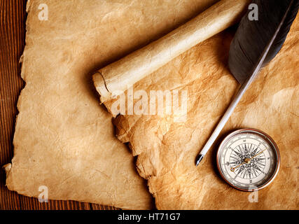 Compass and feather on a old paper Stock Photo