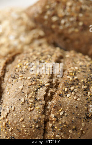 Multigrain wholemeal loaves of bread close up with shallow focus Stock Photo