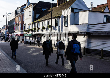 Early morning workers pass The Golden Lion Hotel in the high street, Romford, Dating back to the 16th century. London Borough of Havering, UK Stock Photo