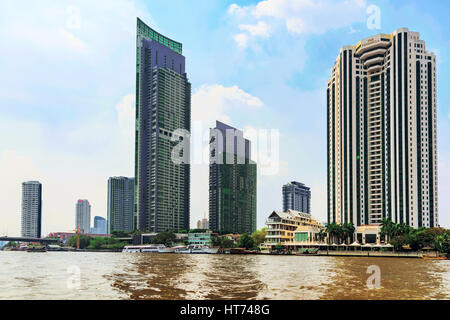 BANGKOK, THAILAND - JANUARY 30: View of the Peninsula hotel and other luxury modern apartment buildings and hotels along the Chao Phraya river on Janu Stock Photo