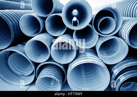 background of colorful big plastic pipes used at the building site. Stock Photo