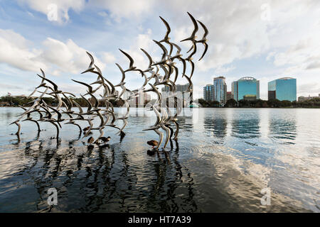 Sculpture Take Flight by artist Douwe Blumberg on Lake Eola in Orlando, Florida. Lake Eola Park is located in the heart of Downtown Orlando and home to the Walt Disney Amphitheater. Stock Photo