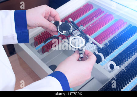 Close-up of optometrist holding messbrille glasses in ophthalmology clinic. Ophthalmic glasses for diopter detection. Stock Photo