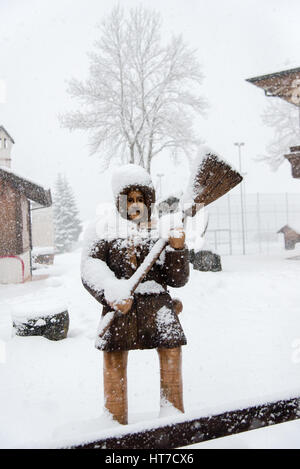 Snow on the wooden statue Stock Photo