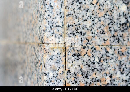 Polished granite wall. Outside corner junction granite slabs Stock Photo