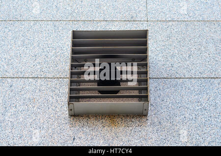 Ventilation grille on granite wall of modern building. Facade element Stock Photo