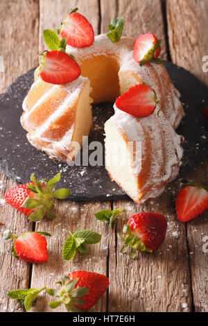 sliced bundt cake with strawberries fresh organic natural ingredients sweet treat. Vertical Stock Photo