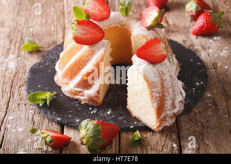 Pound Cake cake with mint and strawberry close-up on the table. Horizontal Stock Photo