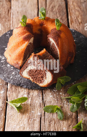 Closeup of a marble cake with vanilla and cocoa closeup on the table.  Vertical Stock Photo