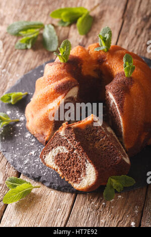 Homebaked marble bundt cake on rustic wooded table. Vertical Stock Photo